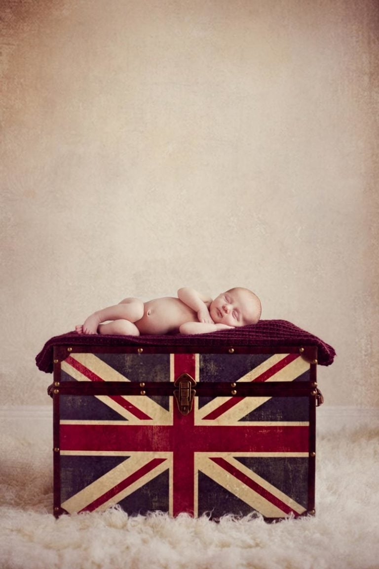 newborn baby girl sleeping on the UK union jack design box