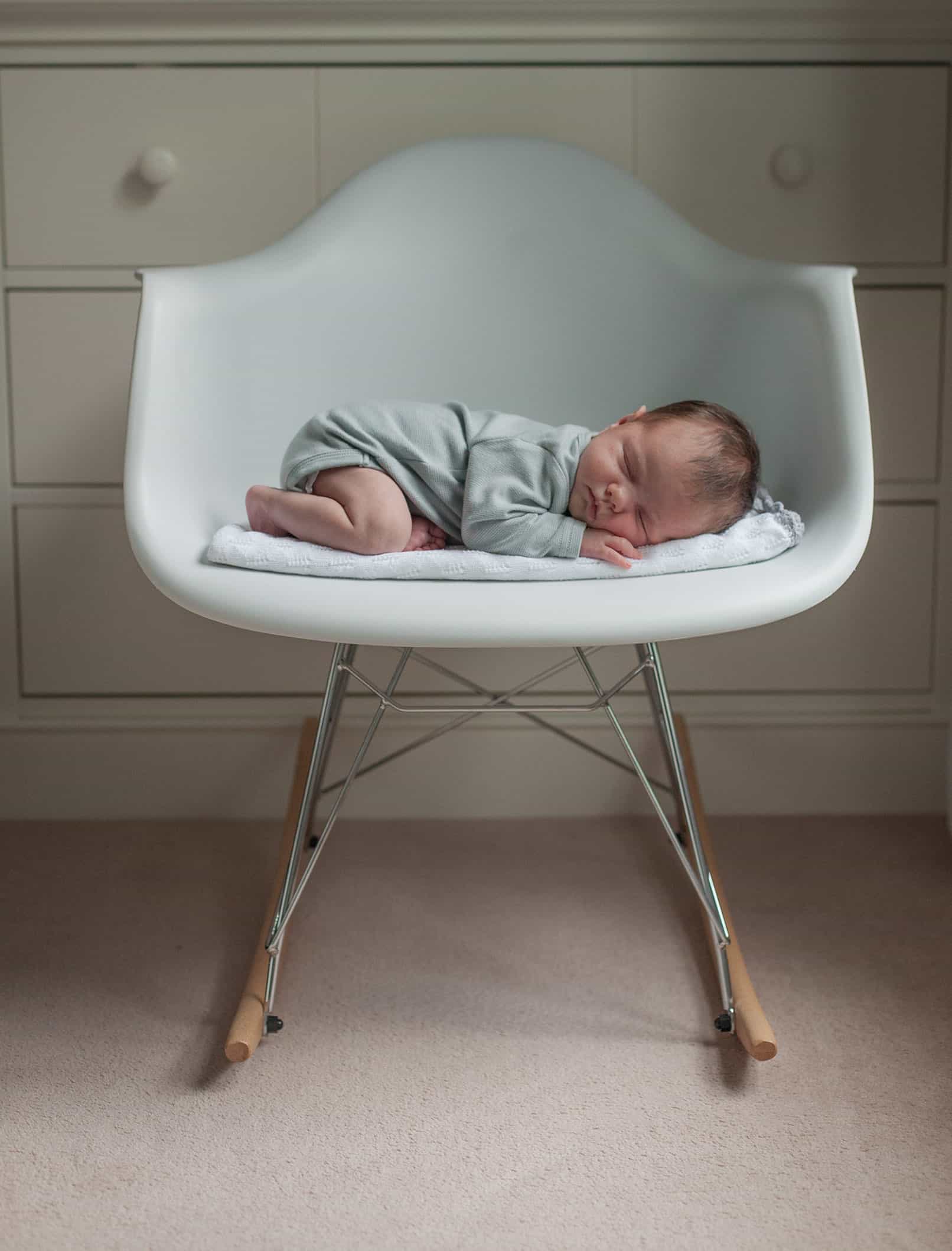 Newborn photos at home. baby on the chair