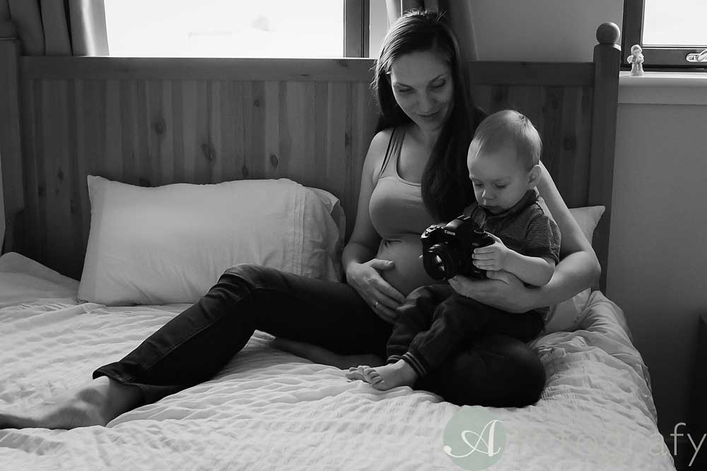 mum and baby during home maternity session sitting on the bed