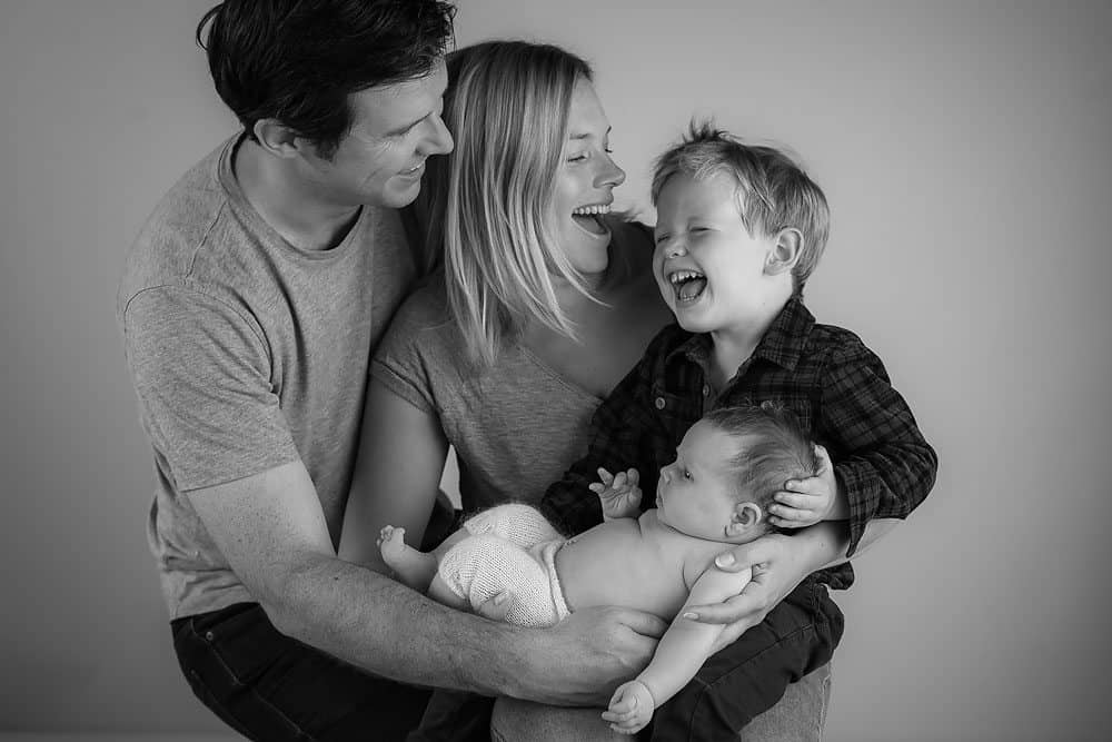 Black and white fun newborn family photography portrait