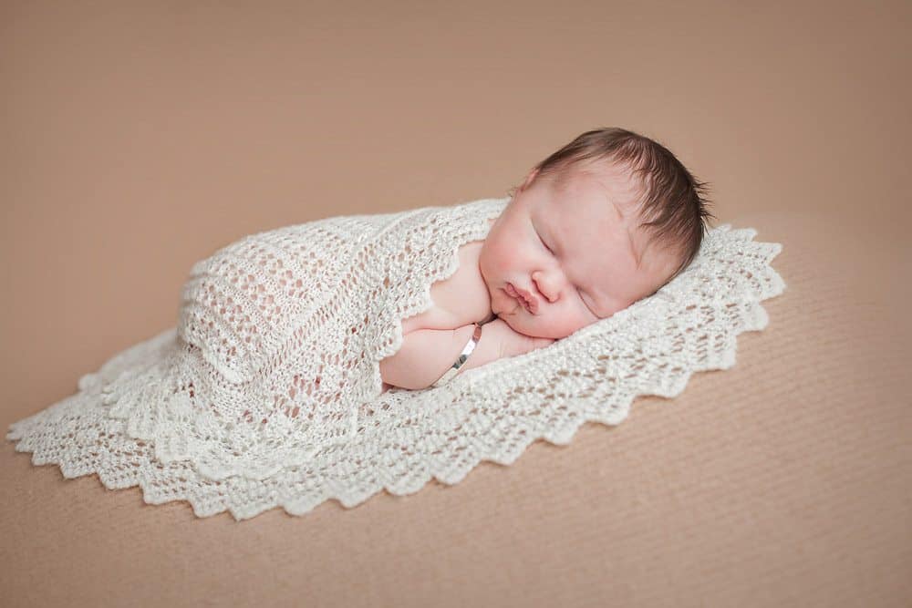 Newborn baby wrapped in heirloom blanket passed onto generations