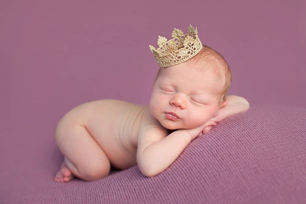 newborn girl wearing a crown for photo shoot
