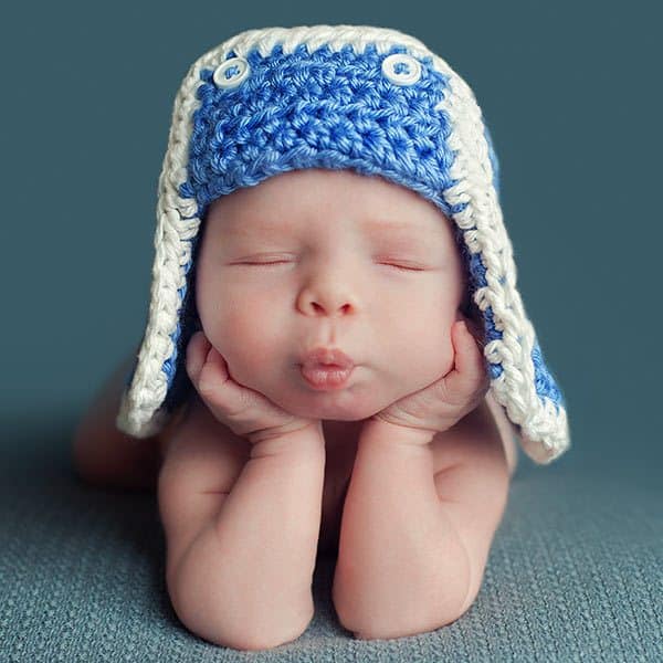 Newborn frog pose done on blue background. Blue hat. Edinburgh newborn studio