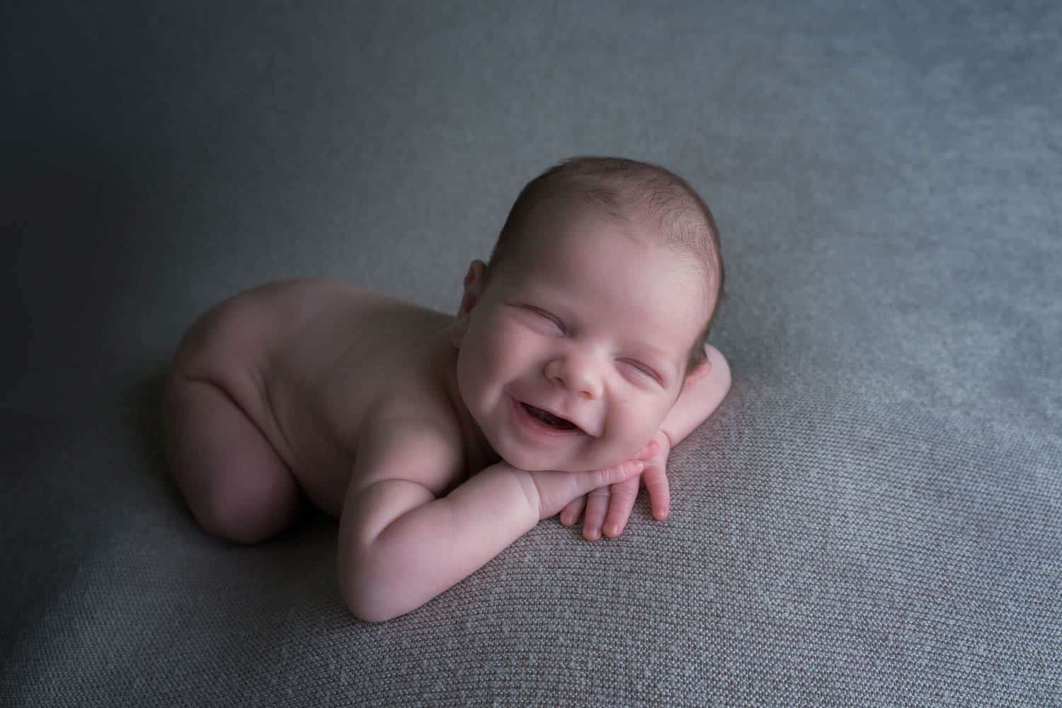 newborn baby smiling during session in Edinburgh photo studio