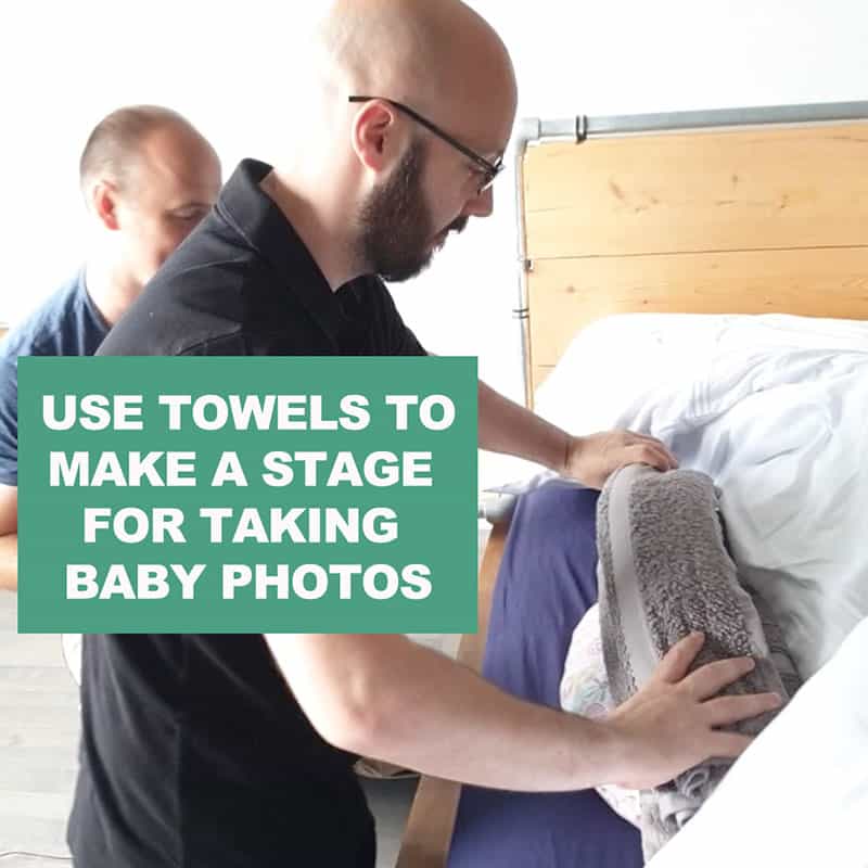 use towels to prop baby during diy photoshoot at home