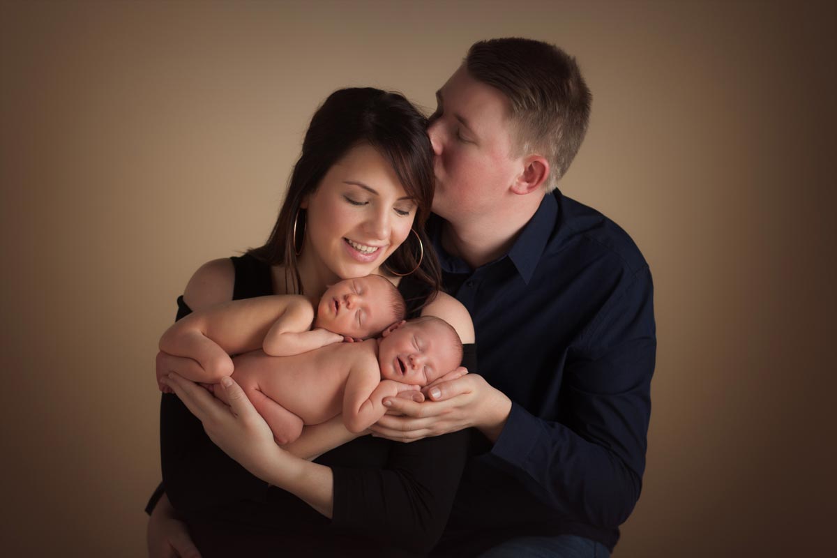 Family holding newborn twins