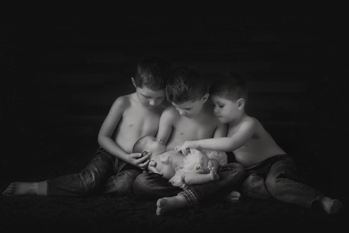 Classic black and white sibling group with newborn baby girl photos