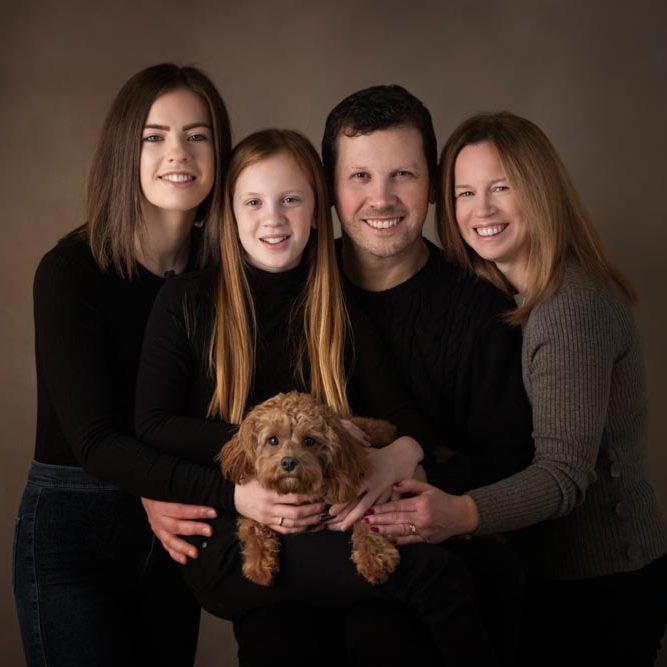 classic studio family portrait with dog