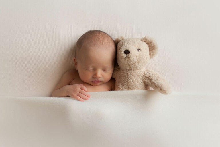 Newborn photographer in edinburgh photographing bay with toy teddy